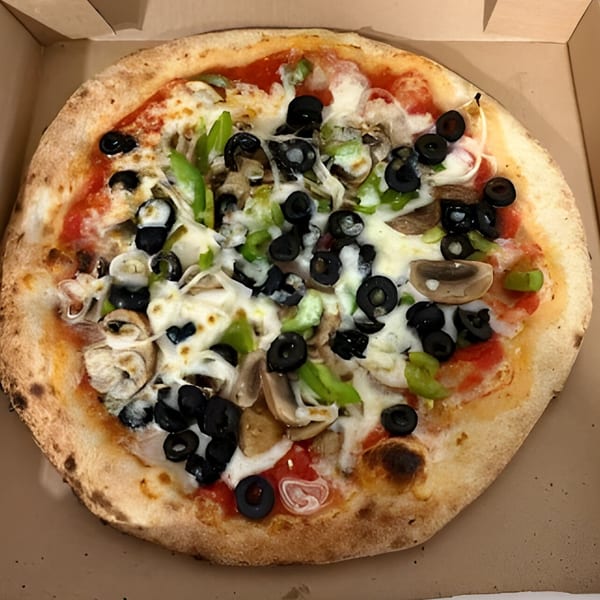 CraveN Pizza's whole pizza with black olives, green peppers, and mushrooms in a box.